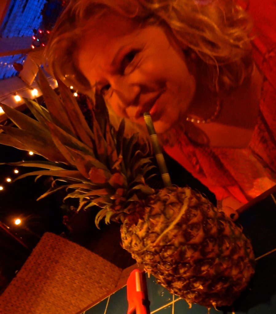 Bridget drinking a pineapple drink picture taken by John
