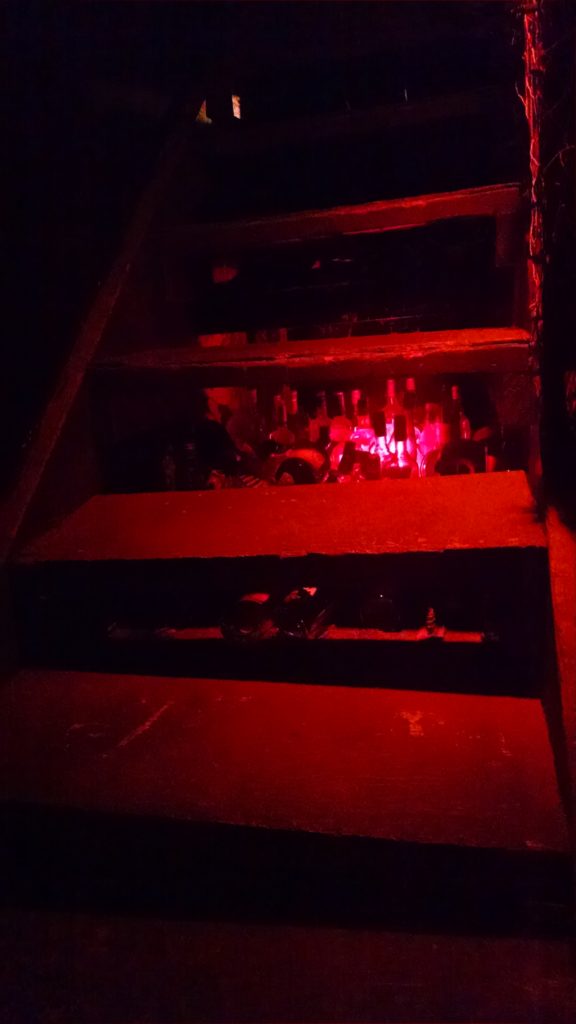 Hidden empty bottles under the stairs