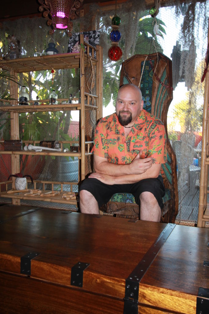Aaron sitting on the Witco Throne at Doctor Voodoo's Tiki Temple