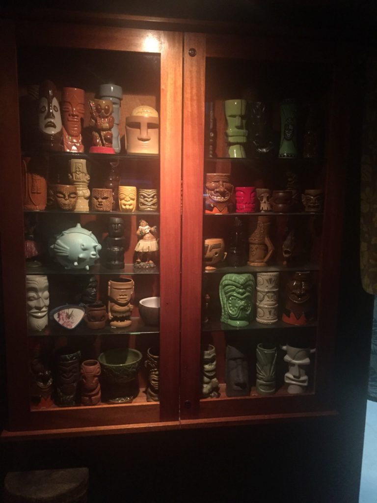 A fine collection of Tiki glasses is on display.