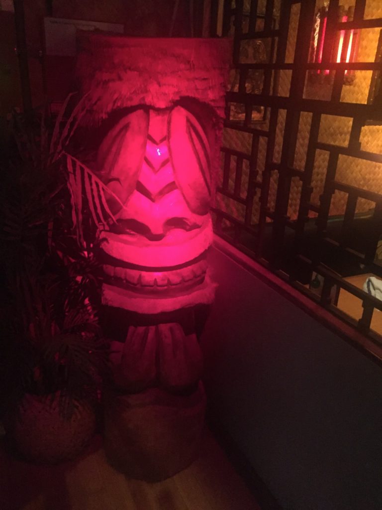 A Tiki greets all who enter the lounge.